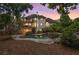 A backyard view with a stone trimmed pool, a raised jacuzzi, and large home with a screened in porch at 510 Northland Ridge Ct, Sandy Springs, GA 30342