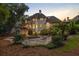 Outdoor living space showcasing a firepit, pool, the home's exterior, and lush landscaping at 510 Northland Ridge Ct, Sandy Springs, GA 30342