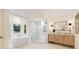 A luxurious bathroom featuring a modern tub, glass shower, and sleek light-wood cabinetry at 510 Northland Ridge Ct, Sandy Springs, GA 30342