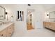 Bright bathroom with dual sinks, marble countertops, and wood cabinets leading to the walk-in closet at 510 Northland Ridge Ct, Sandy Springs, GA 30342