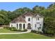 Elegant home boasting manicured lawn, beautiful arched windows, and a welcoming walkway at 510 Northland Ridge Ct, Sandy Springs, GA 30342