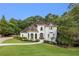 Beautiful two-story home with arched windows, lush landscaping, and a winding walkway at 510 Northland Ridge Ct, Sandy Springs, GA 30342