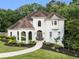 Elegant home featuring a manicured lawn, meticulously landscaped beds, and a charming walkway to the front door at 510 Northland Ridge Ct, Sandy Springs, GA 30342