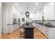 Spacious kitchen featuring a large island and white cabinets with stone countertops at 510 Northland Ridge Ct, Sandy Springs, GA 30342
