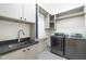 Well-equipped laundry room with modern washer, dryer, utility sink, and ample storage at 510 Northland Ridge Ct, Sandy Springs, GA 30342