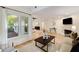 Open-concept layout with a fireplace, hardwood floors, and large windows create an airy and inviting space at 510 Northland Ridge Ct, Sandy Springs, GA 30342