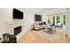 Bright living room features a cozy fireplace, hardwood floors, and a large bay window with natural light at 510 Northland Ridge Ct, Sandy Springs, GA 30342