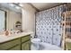 Bathroom featuring decorative shower curtain, vanity, and patterned floor at 578 Mcgill Ne Pl # 578, Atlanta, GA 30312