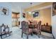 Cozy dining area with glass table, decorative chairs, and adjacent view into the kitchen at 578 Mcgill Ne Pl # 578, Atlanta, GA 30312