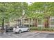 Exterior shot of condos under shade trees; convenient guest parking at 578 Mcgill Ne Pl # 578, Atlanta, GA 30312