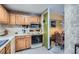 A kitchen with traditional wood cabinets and white appliances at 578 Mcgill Ne Pl # 578, Atlanta, GA 30312