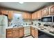 Traditional kitchen features wood cabinetry, white appliances and white countertops at 578 Mcgill Ne Pl # 578, Atlanta, GA 30312