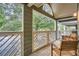 Relaxing covered patio with wooden floors, chairs, and backyard views at 578 Mcgill Ne Pl # 578, Atlanta, GA 30312
