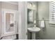 Charming powder room features a pedestal sink and shuttered window at 1370 Dupont Nw Park, Atlanta, GA 30318