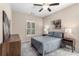 This bedroom features a ceiling fan, neutral colored walls, a dresser, and matching bedside tables at 1370 Dupont Nw Park, Atlanta, GA 30318