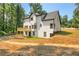 Exterior view of the rear of the home with a deck and landscaped yard at 3439 Twin Village Ct, Snellville, GA 30039