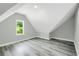 A well-lit bedroom features sleek gray walls, wood-look flooring, and ample natural light from a charming window at 3439 Twin Village Ct, Snellville, GA 30039