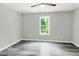 Neutral bedroom with vinyl floors features a window overlooking lush backyard greenery at 3439 Twin Village Ct, Snellville, GA 30039