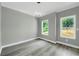 Bedroom featuring gray walls, light trim, wood-look floors, and bright natural light at 3439 Twin Village Ct, Snellville, GA 30039