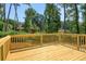 New deck provides a serene outdoor living space surrounded by mature trees at 3439 Twin Village Ct, Snellville, GA 30039