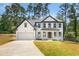 Charming two-story home boasts a manicured lawn and inviting front porch at 3439 Twin Village Ct, Snellville, GA 30039