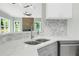 Modern kitchen featuring light countertops, gray cabinets, and stainless steel appliances at 3439 Twin Village Ct, Snellville, GA 30039