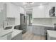 Modern kitchen with white cabinets, stainless steel appliances, and tiled backsplash at 3439 Twin Village Ct, Snellville, GA 30039