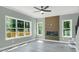 Living room boasting large windows, wood-look floors, and a feature wall with a fireplace at 3439 Twin Village Ct, Snellville, GA 30039