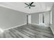 Spacious primary bedroom showcasing wood-look floors and an en-suite bath at 3439 Twin Village Ct, Snellville, GA 30039