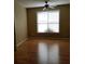 Bedroom with hardwood flooring, ceiling fan, and large window at 5252 Inverness Ct, Douglasville, GA 30135