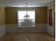 Dining room with neutral paint, window with natural light, and decorative chandelier at 5252 Inverness Ct, Douglasville, GA 30135