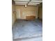 Spacious two-car garage with overhead lighting and storage shelves, providing secure parking and ample space for tools at 5252 Inverness Ct, Douglasville, GA 30135