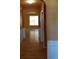 Hallway with hardwood floors and decorative molding leads to a living area with natural light at 5252 Inverness Ct, Douglasville, GA 30135