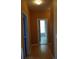 Hallway with laminate flooring that leads to a bathroom with a window at 5252 Inverness Ct, Douglasville, GA 30135