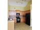 Functional kitchen with wooden cabinets, black appliances, and plenty of counter space at 5252 Inverness Ct, Douglasville, GA 30135