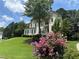 Charming two-story home featuring lush landscaping, a manicured lawn, and mature trees, creating inviting curb appeal at 600 Oakmont Hl, Duluth, GA 30097