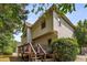 View of house exterior highlighting the deck, lush greenery, and multi-story structure at 600 Oakmont Hl, Duluth, GA 30097