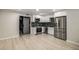 Modern kitchen featuring stainless steel appliances, white cabinetry, and green backsplash at 600 Oakmont Hl, Duluth, GA 30097