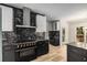Contemporary kitchen featuring stainless steel range hood and dark cabinets at 600 Oakmont Hl, Duluth, GA 30097