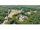 Stunning aerial view of a beautiful estate surrounded by lush greenery and mature trees at 604 Trinity Church Rd, Canton, GA 30115