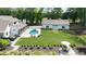 An entertainer's dream backyard with pool, hot tub, pool house, outdoor seating and lush landscaping at 604 Trinity Church Rd, Canton, GA 30115