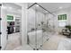 Bathroom featuring a freestanding tub inside a frameless glass shower and walk-in closet at 604 Trinity Church Rd, Canton, GA 30115
