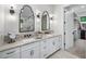 Bathroom with dual sinks, marble countertops, modern faucets, custom mirrors and walk-in closet at 604 Trinity Church Rd, Canton, GA 30115