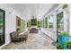 Inviting outdoor patio featuring a stone floor, wicker furniture, and a cozy fireplace at 604 Trinity Church Rd, Canton, GA 30115