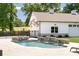 Backyard pool with a waterfall feature beside the garage at 604 Trinity Church Rd, Canton, GA 30115
