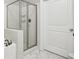 Modern bathroom with a glass-enclosed shower and white tile surround at 901 Abernathy Rd # 2200, Sandy Springs, GA 30328