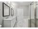 Elegant bathroom with marble floors, dual vanities, and a glass-enclosed shower at 901 Abernathy Rd # 2200, Sandy Springs, GA 30328