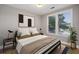 Well-lit bedroom featuring a cozy bed, stylish decor, and large windows at 901 Abernathy Rd # 2200, Sandy Springs, GA 30328