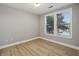 Serene bedroom with hardwood floors, two windows, and ample natural light at 901 Abernathy Rd # 2200, Sandy Springs, GA 30328