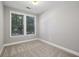 Bright bedroom with neutral walls, carpet flooring and view from windows at 901 Abernathy Rd # 2200, Sandy Springs, GA 30328